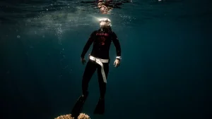 freediver in the red sea near a coral